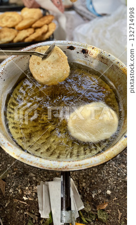 Hand frying pastries. High quality photo Hand frying pastries. High quality photo 132714998
