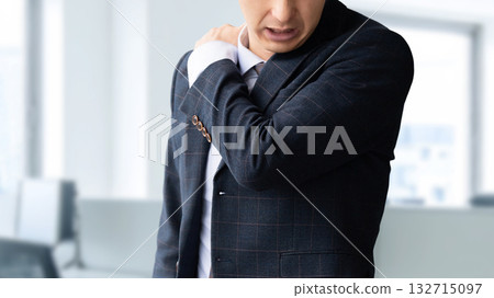 Male businessman suffering from stiff shoulders Male businessman suffering from stiff shoulders 132715097