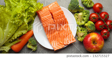 Fresh raw healthy food vegetables fruit salmon fillet grey background, inflammatory diet, clean eating 132715327