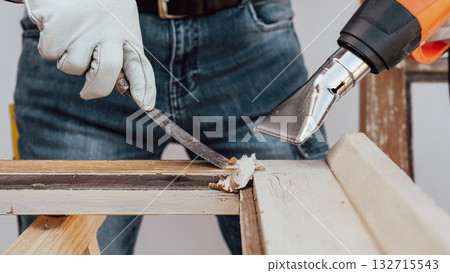 Carpenter at work, restoring an old wooden window. Carpentry. 132715543