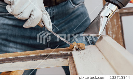 Carpenter at work, restoring an old wooden window. Carpentry. 132715544
