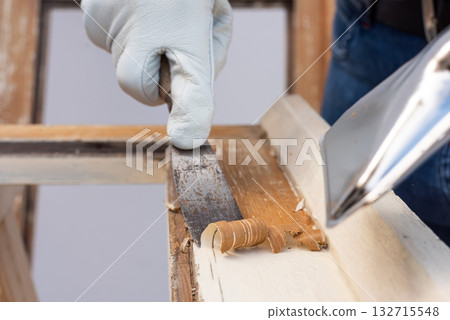 Carpenter at work, restoring an old wooden window. Carpentry. 132715548