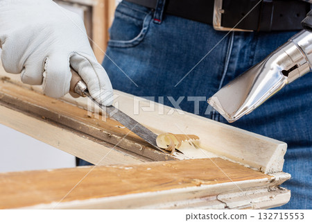 Carpenter at work, restoring an old wooden window. Carpentry. Carpenter at work, restoring an old wooden window. Carpentry. 132715553