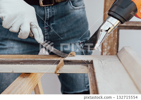 Carpenter at work, restoring an old wooden window. Carpentry. 132715554