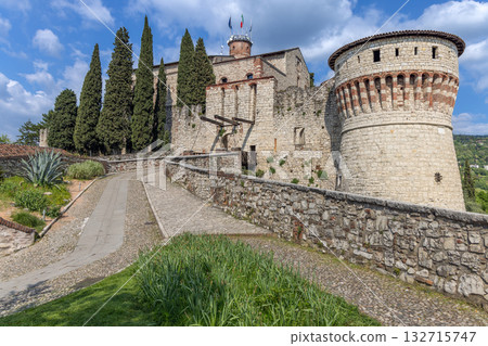 Brescia Castle shows stone walls Prisoners and Mirabella Towers standing high over green hill Brescia Castle shows stone walls Prisoners and Mirabella Towers standing high over green hill 132715747