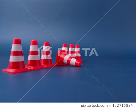 The image shows several miniature traffic cones, with one lying on its side. 132715884