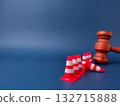 The combination of a gavel and traffic cones can symbolize legal obstacles or the law creating barriers. 132715888