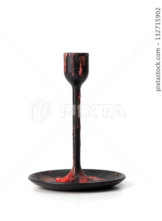 Black metal candle holder covered with red wax drips, isolated on white background, gothic style object. 132715902
