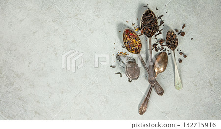 Assorted Loose Leaf Teas in Vintage Spoons on Stone Background Assorted Loose Leaf Teas in Vintage Spoons on Stone Background 132715916