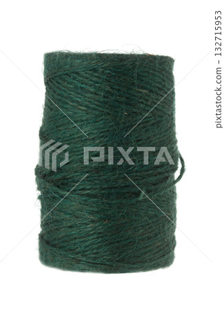 Dark green natural fiber twine or yarn tightly wound on a brown spool, isolated against a plain white background. 132715953