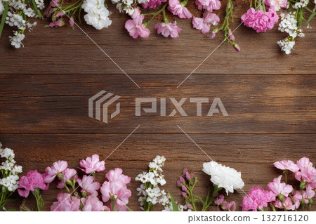Spring Flowers Create a Colorful Border on a Rustic Wooden Table Spring Flowers Create a Colorful Border on a Rustic Wooden Table 132716120