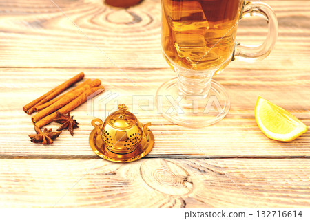Cup of Cinnamon Lemon Tea on Wooden Table 132716614