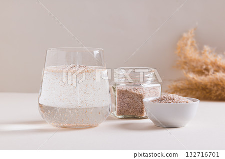 A glass of water and psyllium husk on the table for health A glass of water and psyllium husk on the table for health 132716701