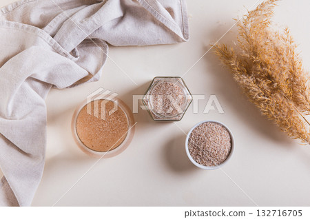 A glass of water and psyllium husk on the table for health  top view 132716705