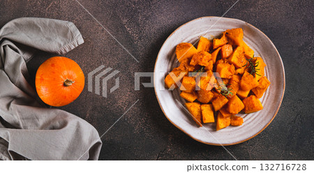 Roasted pumpkin with rosemary on a plate on the table top view web banner Roasted pumpkin with rosemary on a plate on the table top view web banner 132716728