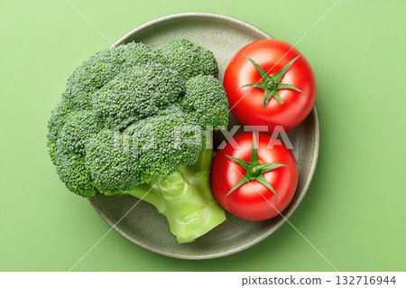 Broccoli and Tomatoes on Plate (Green Background) Broccoli and Tomatoes on Plate (Green Background) 132716944