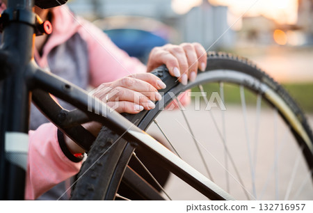 Close Up Of Girl Checking Bike Tire Pressure Close Up Of Girl Checking Bike Tire Pressure 132716957