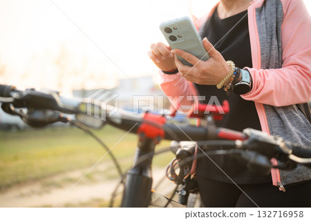 Woman Checking Bike Route On A Smartphone With Gps Map Woman Checking Bike Route On A Smartphone With Gps Map 132716958