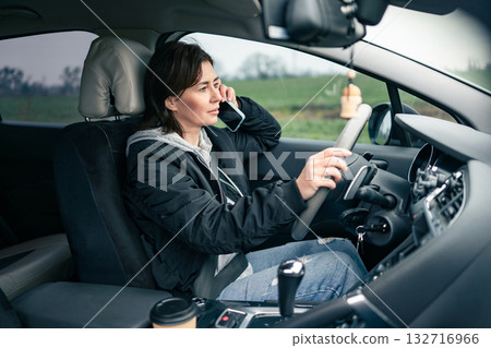 Woman Driver Taking A Phone Talk During A Long Car Trip 132716966