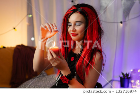 Cute Little Girl In A Halloween Costume Having Fun With Candles In A Decorated Room Cute Little Girl In A Halloween Costume Having Fun With Candles In A Decorated Room 132716974