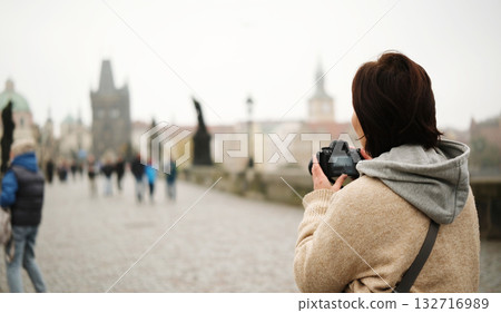 Girl Captures Stunning Charles Bridge. Tourists Stroll Through Prague Magic 132716989