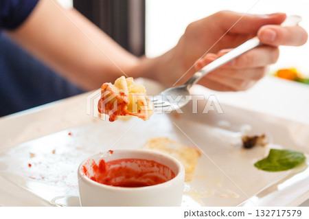 Eating pancake with strawberry sauce 132717579