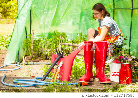 Female farmer and gardening tools in garden Female farmer and gardening tools in garden 132717595
