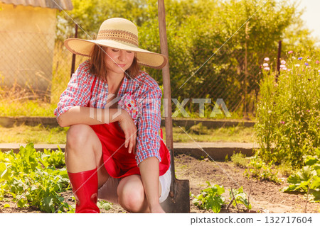 woman with gardening tool working in garden 132717604