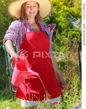 woman watering flowers in garden 132717608