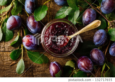 Homemade Plum Jam in a Glass Jar With Fresh Plums and Leaves on a Wooden Background 132717655