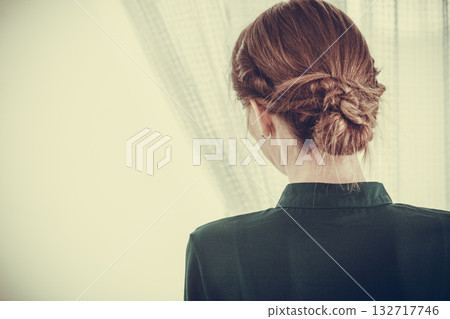Alone woman looking through window waiting Alone woman looking through window waiting 132717746
