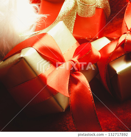 Small red and golden boxes with gifts tied bows Small red and golden boxes with gifts tied bows 132717892