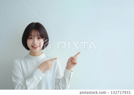 A female model pointing with a smile, symbolizing a proposal or introduction 132717931