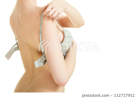 Attractive slim woman taking off grey bra 132717952