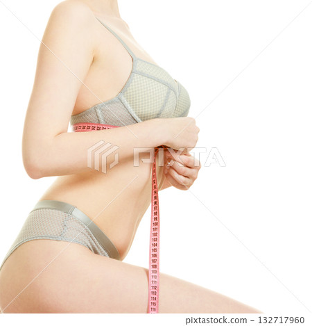 Woman measuring her under breasts. 132717960