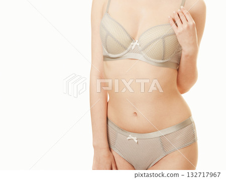 Attractive slim woman in grey matching underwear Attractive slim woman in grey matching underwear 132717967