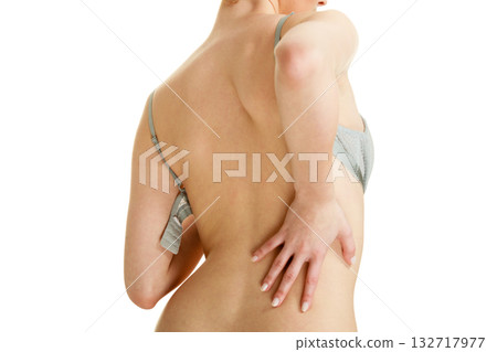 Attractive slim woman taking off grey bra Attractive slim woman taking off grey bra 132717977