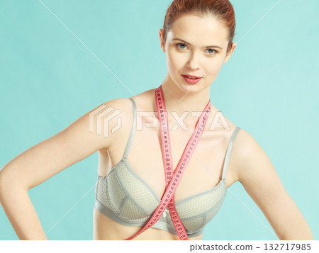 Woman in underwear with measure tape 132717985