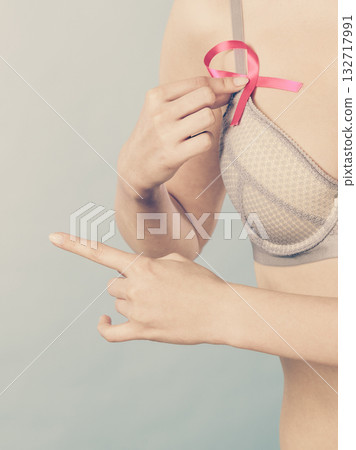 woman in bra with breast cancer awareness ribbon 132717991
