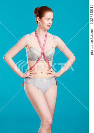 Woman in underwear with measure tape Woman in underwear with measure tape 132718012