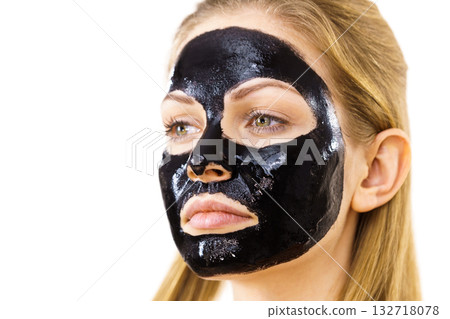 Woman with black peel off mask on face 132718078