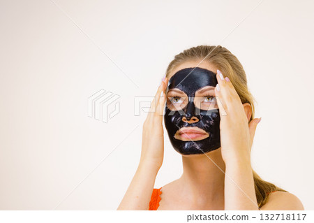 Girl black carbo peel off mask on face 132718117
