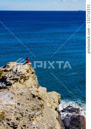 Tourist woman on sea cliffs in Spain 132718331