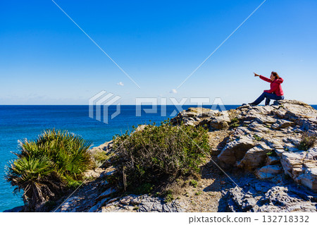 Tourist woman on sea cliffs in Spain Tourist woman on sea cliffs in Spain 132718332