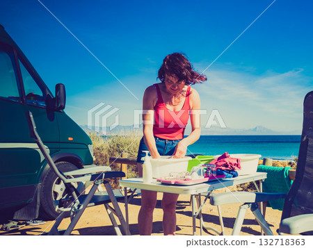 Woman wash dishes in bowl, capming outdoor Woman wash dishes in bowl, capming outdoor 132718363