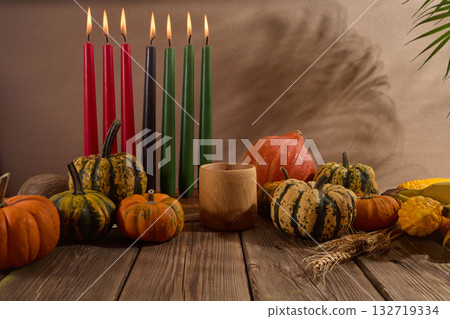 Kwanzaa. African holiday Kwanzaa with decoration of seven candles and pumpkins Kwanzaa. African holiday Kwanzaa with decoration of seven candles and pumpkins 132719334