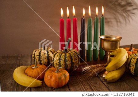 Kwanzaa. African holiday Kwanzaa with decoration of seven candles and pumpkins Kwanzaa. African holiday Kwanzaa with decoration of seven candles and pumpkins 132719341