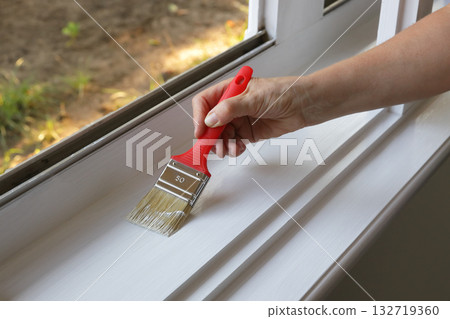 Old house renovation, woman painting window 132719360