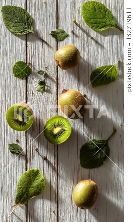 Fresh Sapotes Surrounded by Green Leaves on Rustic Wooden Table in Natural Light 132719611