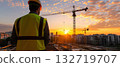 Construction manager observing site at sunrise 132719707